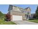 Charming brick and siding home with a two-car garage and a well-manicured front yard at 9840 N Anchor Bnd, McCordsville, IN 46055