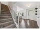Bright foyer with hardwood floors, staircase, and view into the adjacent dining area at 9840 N Anchor Bnd, McCordsville, IN 46055