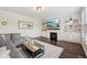 Comfortable living room with a fireplace, built-in shelves, and hardwood flooring at 9840 N Anchor Bnd, McCordsville, IN 46055