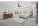 Bright main bedroom with a tray ceiling, large rug, and ample natural light at 9840 N Anchor Bnd, McCordsville, IN 46055