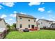 Lush backyard with a two story home, a wooden fence, well-kept lawn, and a cozy red deck at 10306 Mcclain Dr, Brownsburg, IN 46112