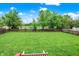 Expansive backyard with lush green grass, a wood fence, and tranquil water view, ideal for outdoor activities at 10306 Mcclain Dr, Brownsburg, IN 46112