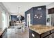 Open-concept dining area flows into a living space, complete with hardwood floors, granite counter, and stainless refrigerator at 10306 Mcclain Dr, Brownsburg, IN 46112