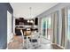 Dining area with a sliding glass door to the outside, dark kitchen cabinets, and modern lighting at 10306 Mcclain Dr, Brownsburg, IN 46112