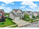A well-manicured home exterior boasts a two-car garage, tasteful stone accents, and inviting curb appeal at 10306 Mcclain Dr, Brownsburg, IN 46112