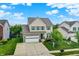 Charming two-story home features a stone-accented facade, two-car garage, and a neatly landscaped front yard at 10306 Mcclain Dr, Brownsburg, IN 46112