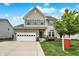 Beautiful two-story home with stone accents, an attached garage, and manicured landscaping at 10306 Mcclain Dr, Brownsburg, IN 46112