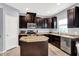 Well-equipped kitchen featuring stainless steel appliances, dark cabinets, and a convenient center island at 10306 Mcclain Dr, Brownsburg, IN 46112