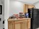 Functional kitchenette area with light wood cabinets, a compact sink, and essential appliances at 10306 Mcclain Dr, Brownsburg, IN 46112