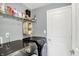 Well-equipped laundry room with modern front-load washer and dryer units and ample shelving at 10306 Mcclain Dr, Brownsburg, IN 46112