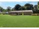 Expansive backyard featuring a yellow door, deck, and lush green lawn perfect for outdoor activities at 11802 Prairie Pl, Carmel, IN 46033
