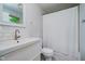 Bright bathroom featuring white subway tiles, sleek fixtures, and a convenient shower with a white shower curtain at 11802 Prairie Pl, Carmel, IN 46033