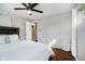 Bedroom with a ceiling fan, a large window, hardwood floors, and a comfortable bed with soft white linens at 11802 Prairie Pl, Carmel, IN 46033
