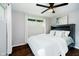 Cozy bedroom with a ceiling fan, a large window, and a comfortable bed with soft white linens at 11802 Prairie Pl, Carmel, IN 46033