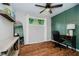 Bright bedroom with a ceiling fan, a large window, hardwood floors and a comfortable desk with an office chair at 11802 Prairie Pl, Carmel, IN 46033