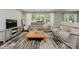Cozy living room with comfortable seating and a large window overlooking the greenery at 11802 Prairie Pl, Carmel, IN 46033