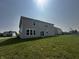 Spacious backyard featuring a well-maintained lawn and a view of the home's rear exterior at 1218 Bedford Dr, Avon, IN 46123