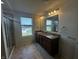 Bathroom features double vanity, granite counters, tile flooring, and shower with glass doors at 1218 Bedford Dr, Avon, IN 46123