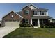 Charming two-story home featuring brick and gray siding, a two-car garage, and well-maintained landscaping at 1218 Bedford Dr, Avon, IN 46123