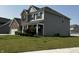 A lovely two-story home with a welcoming front porch, complemented by lush green landscaping at 1218 Bedford Dr, Avon, IN 46123