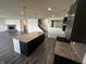 Contemporary kitchen featuring a spacious island, granite countertops, stainless steel appliances and hardwood floors at 1218 Bedford Dr, Avon, IN 46123