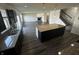 Modern kitchen with granite countertops, stainless steel sink, an island and seamless flow to the living space at 1218 Bedford Dr, Avon, IN 46123