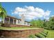 Spacious backyard featuring a retaining wall, well-maintained lawn, and mature trees at 12207 Blue Sky Dr, Fishers, IN 46037