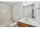 Bright bathroom featuring tiled shower/bathtub, vanity, toilet and a large mirror at 12207 Blue Sky Dr, Fishers, IN 46037