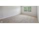 This bedroom offers a peaceful retreat with soft neutral carpeting and walls and a window for natural light at 12207 Blue Sky Dr, Fishers, IN 46037