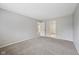 Spacious bedroom offers multiple doorways, neutral carpeting and walls, and natural light at 12207 Blue Sky Dr, Fishers, IN 46037