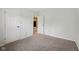 This bedroom has neutral walls and carpeting and multiple doors for closet and hallway access at 12207 Blue Sky Dr, Fishers, IN 46037