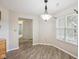 Bright dining area featuring wood floors, large windows and modern lighting fixture at 12207 Blue Sky Dr, Fishers, IN 46037