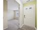 Inviting foyer with a white front door, neutral walls, and views into the carpeted living space at 12207 Blue Sky Dr, Fishers, IN 46037