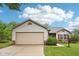 Charming single-story home featuring neutral siding, a two-car garage, and a beautifully landscaped front yard at 12207 Blue Sky Dr, Fishers, IN 46037