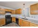 Kitchen featuring stainless steel appliances, modern countertops, tile backsplash, and wood cabinets at 12207 Blue Sky Dr, Fishers, IN 46037