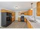 Modern kitchen with stainless steel appliances, wood cabinets, sleek countertops, and tile backsplash at 12207 Blue Sky Dr, Fishers, IN 46037