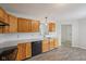 Kitchen featuring stainless steel appliances, wood cabinets, sleek countertops, and tile backsplash at 12207 Blue Sky Dr, Fishers, IN 46037