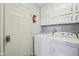 This laundry room is equipped with appliances and storage cabinets for convenience at 12207 Blue Sky Dr, Fishers, IN 46037