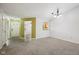 An open living room with neutral walls and carpet, and a view into the kitchen and entryway at 12207 Blue Sky Dr, Fishers, IN 46037
