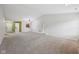 An open living room with neutral walls and carpet, a view into the kitchen and entry at 12207 Blue Sky Dr, Fishers, IN 46037