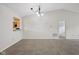 Bright living room featuring neutral walls and carpet, as well as a pass-through to the kitchen at 12207 Blue Sky Dr, Fishers, IN 46037