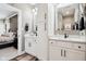 Bathroom featuring dual sinks, quartz counters and modern fixtures, connecting to a Primary bedroom at 1295 Maclaren Ct, Franklin, IN 46131