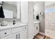Bright bathroom featuring double sink vanity with white cabinets, black hardware, and updated tile shower at 1295 Maclaren Ct, Franklin, IN 46131