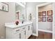 Bright bathroom featuring single sink vanity with white cabinets, black hardware, and modern decor at 1295 Maclaren Ct, Franklin, IN 46131