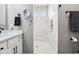 Updated bathroom featuring single sink vanity and walk-in shower with marble tile and frameless glass enclosure at 1295 Maclaren Ct, Franklin, IN 46131