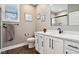 Bright bathroom featuring single sink vanity with white cabinets, black hardware, and window at 1295 Maclaren Ct, Franklin, IN 46131
