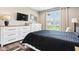Serene bedroom with large dresser, flat screen television, and a bright window at 1295 Maclaren Ct, Franklin, IN 46131