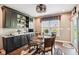 Cozy dining area with dark cabinetry, decorative lighting and table near sliding glass doors at 1295 Maclaren Ct, Franklin, IN 46131
