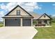 Charming home with a spacious two-car garage, brick accents, and a well-manicured lawn under a bright blue sky at 1295 Maclaren Ct, Franklin, IN 46131