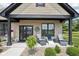 Inviting front porch with seating area, decorative wreath, and well-maintained landscaping, enhancing curb appeal at 1295 Maclaren Ct, Franklin, IN 46131